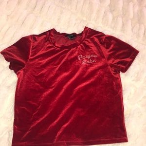 A velvet red top with rhinestones words
